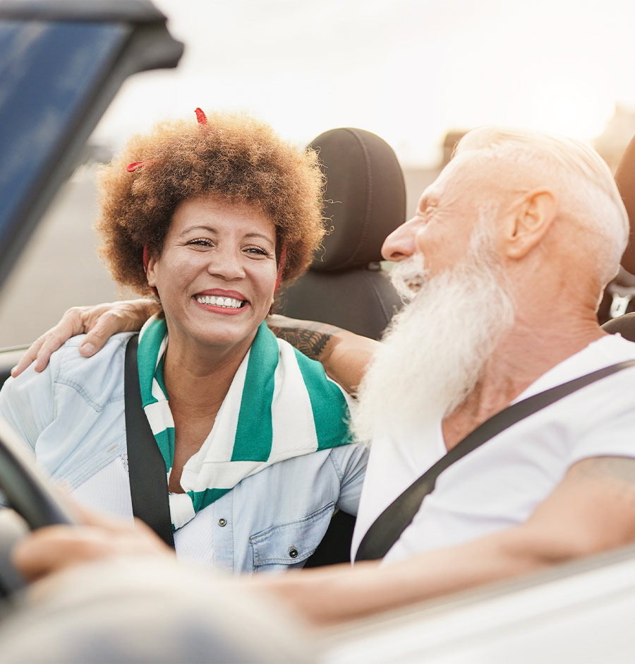 couple smiling while driving in convertible simple retirement options
